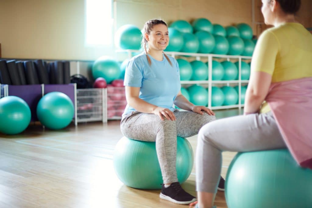 Women on Yoga ball doing pelvic floor PT