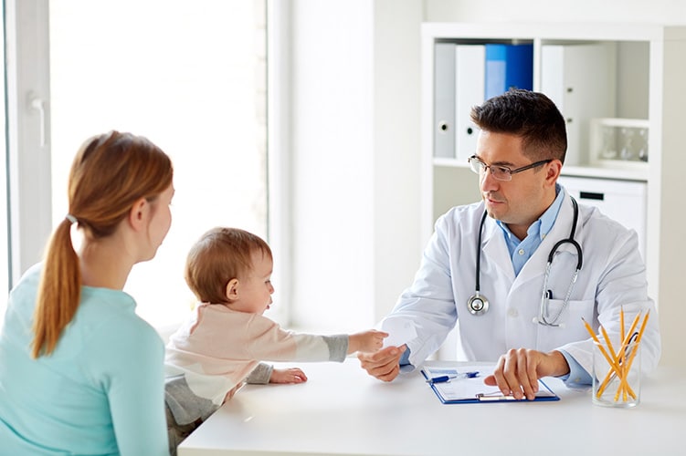 Doctor with a woman and her child - Family Medicine Manhattan New York