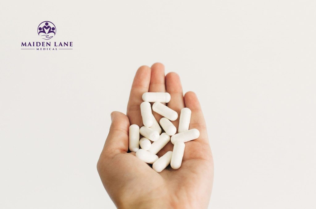 A patient in NYC holding calcium supplements in their hand.