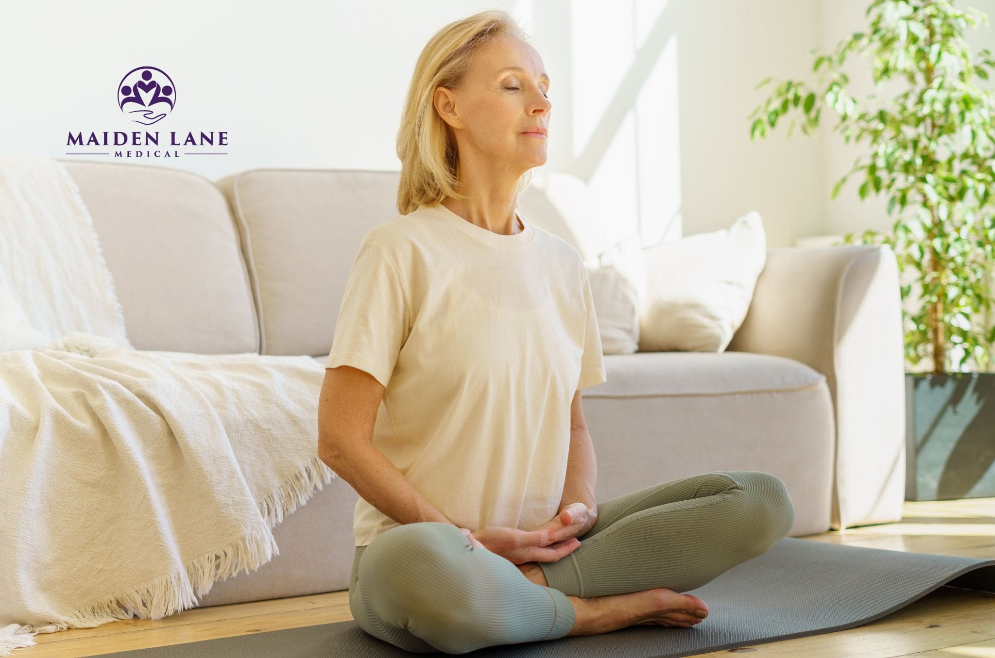 Woman indoors trying stimulating breathing technique in Manhattan, NY.
