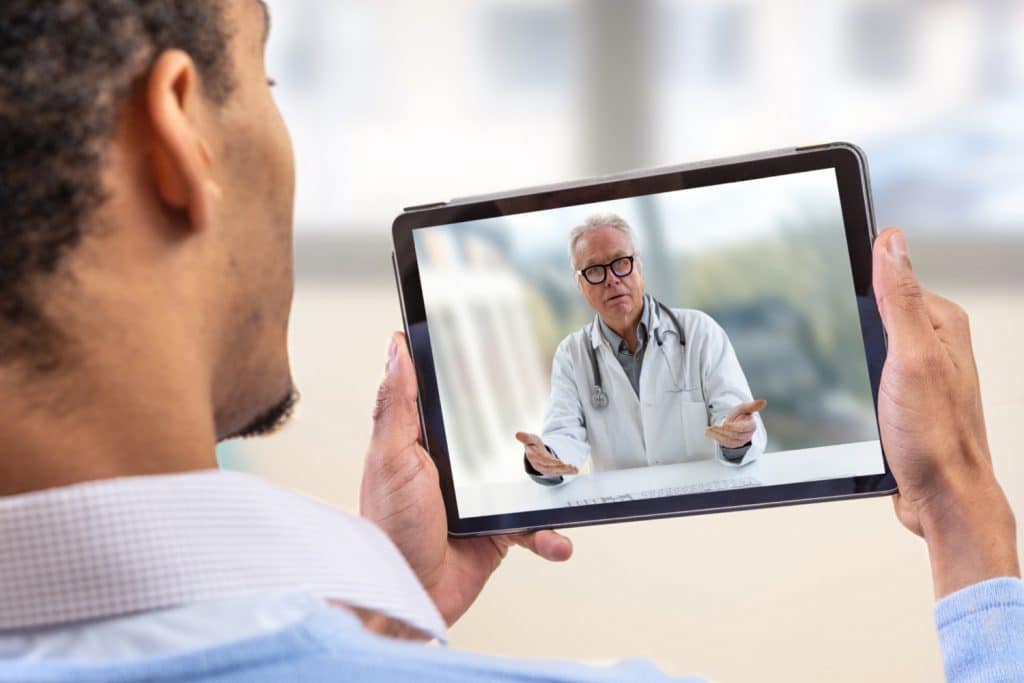Telemedicine Manhattan New York - Man having a telemedicine appointment with doctor on tablet