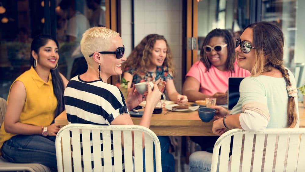 Smiling women sharing a meal at restaurant