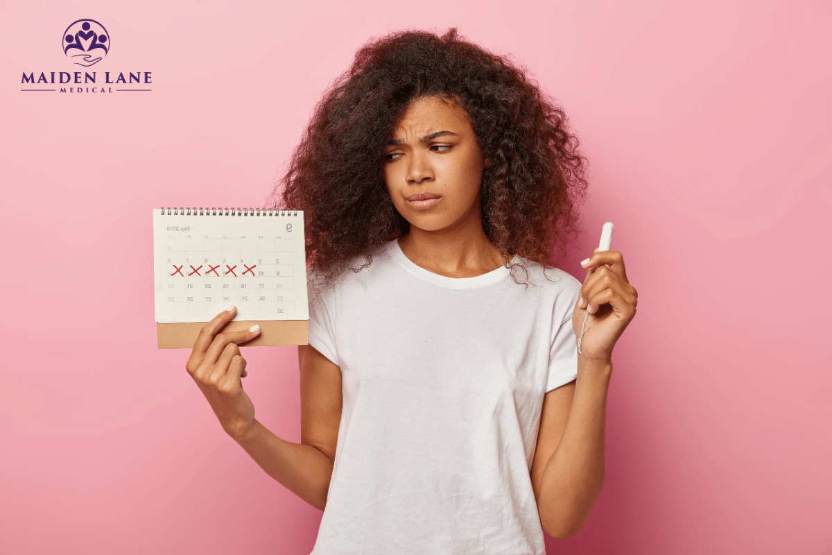 A woman holding a calendar and tampon wondering about when her period is coming in New York, Manhattan.