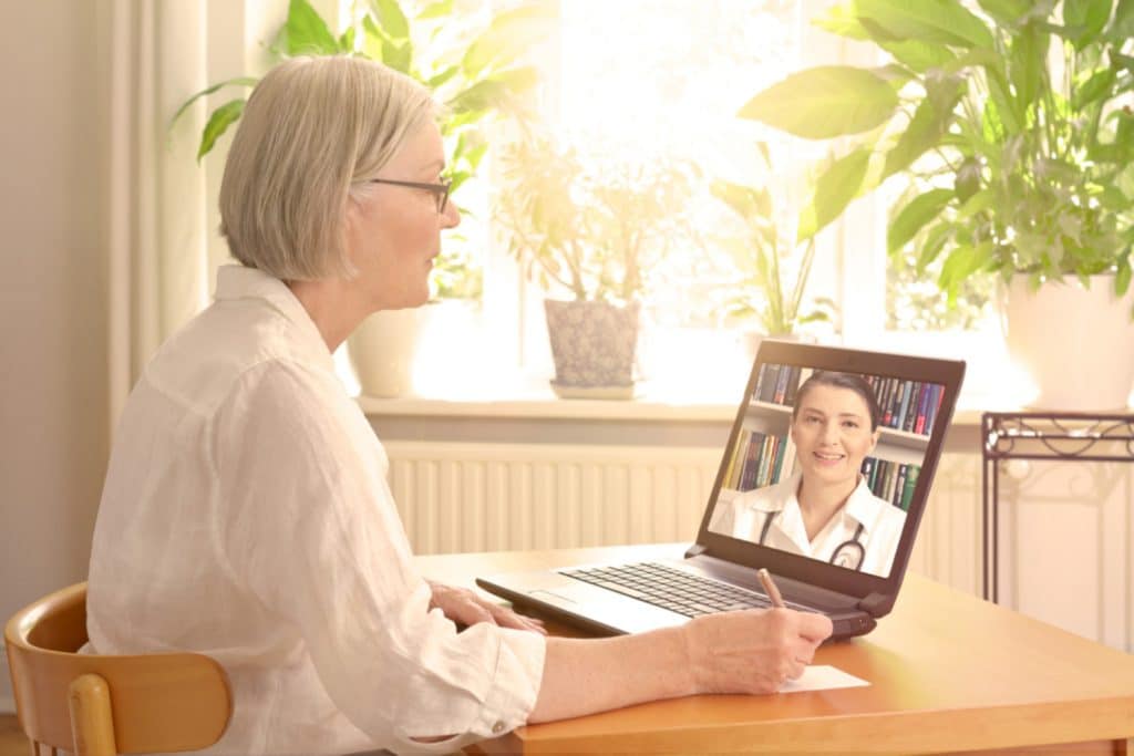 Woman using laptop to talk to doctor - Telemedicine Appointment New York