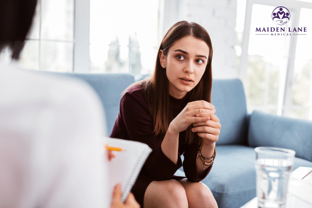 A woman talking about her mental health challenges with a doctor in New York.