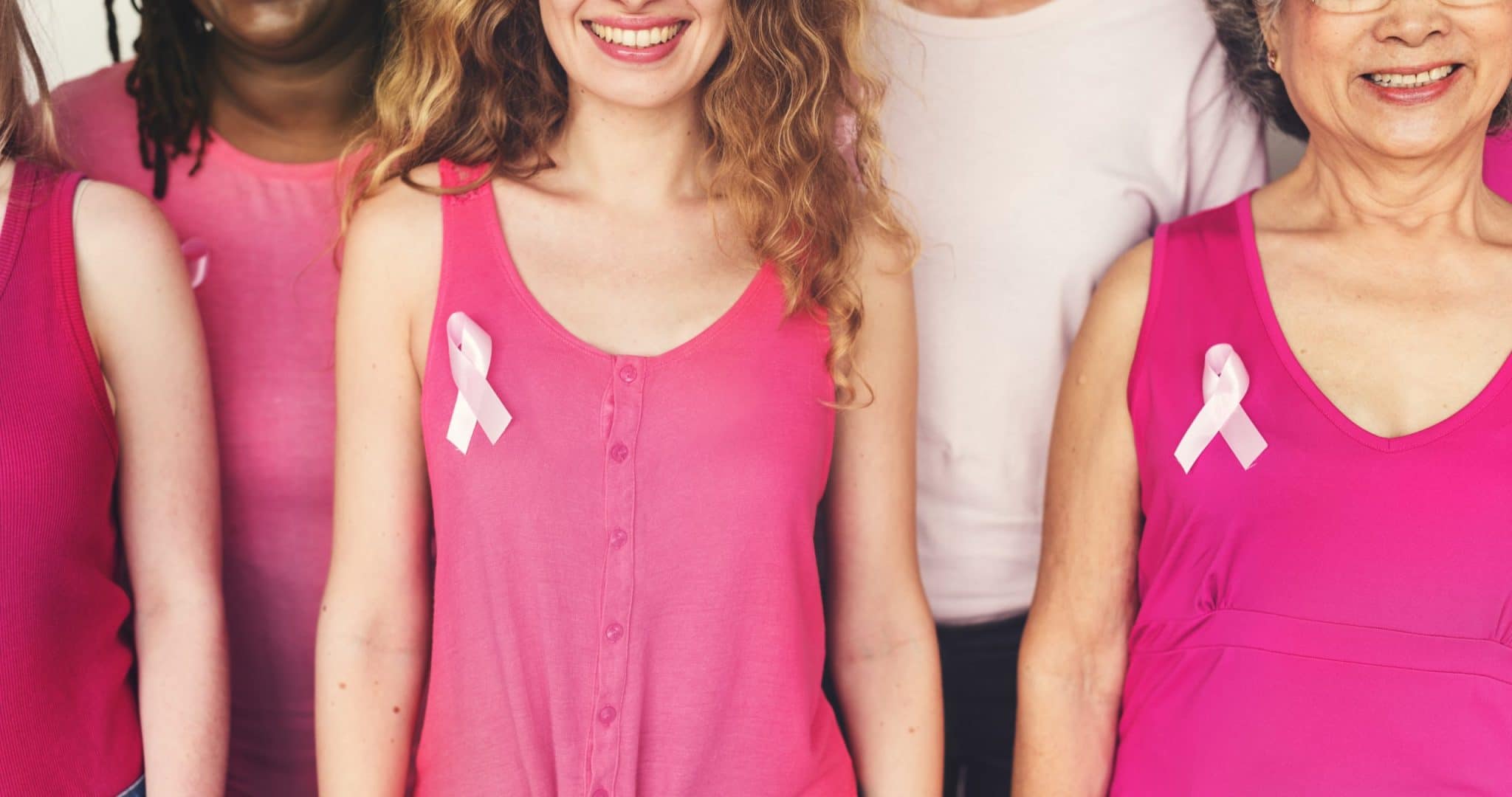 Women with pink ribbon for breast cancer awareness month 2021
