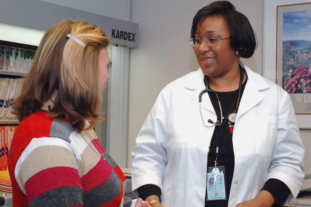 Doctor in NYC offering primary care to a patient.