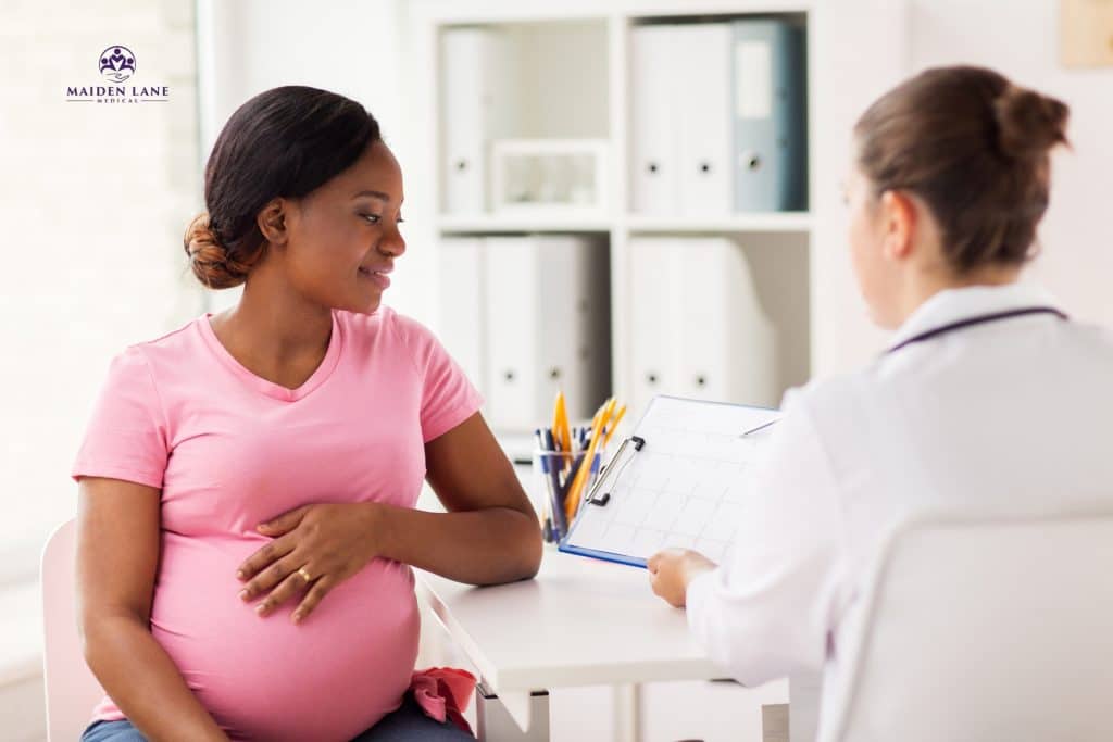 Female doctor speaking with her pregnant patient about her pregnancy. Maiden Lane Medical | New York, NY