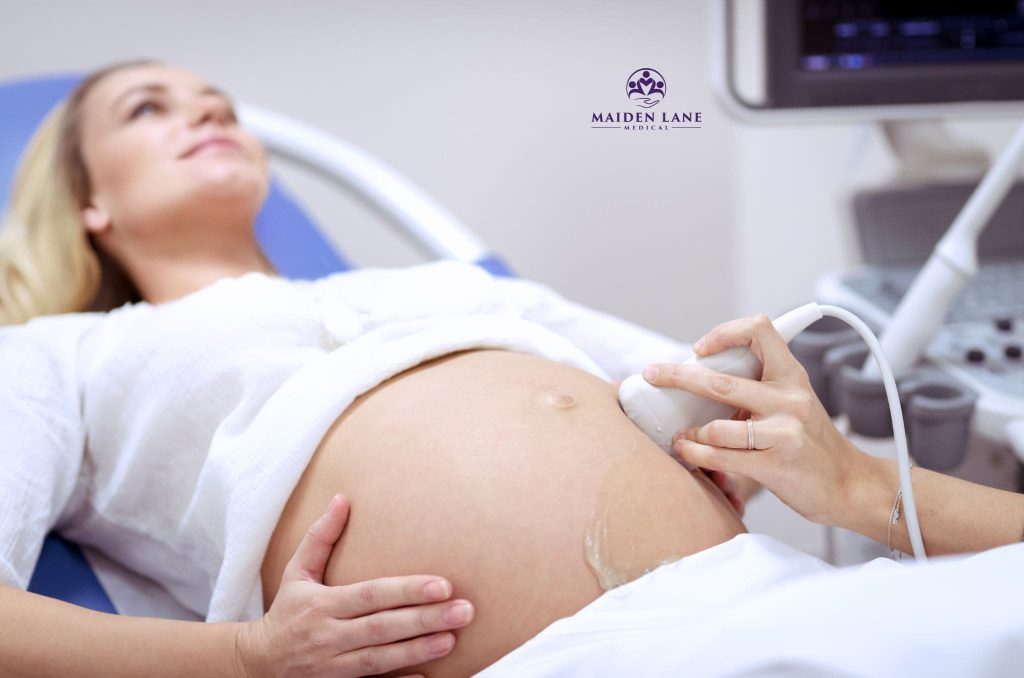 A pregnant woman getting an ultrasound during her visit to the OB/GYN.