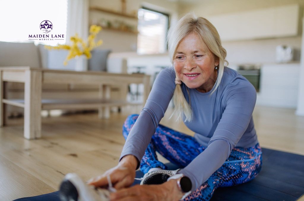 An older woman stretching to help her joint pain in Manhattan, NY.