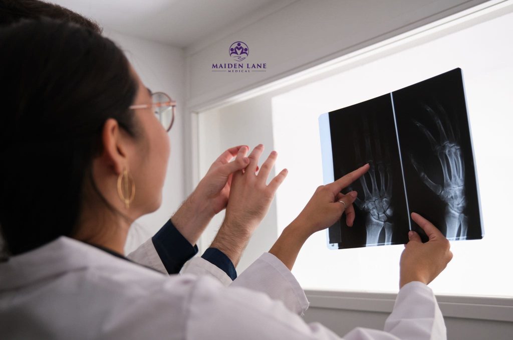 A rheumatoid arthritis specialist in NYC examining joint x-rays.