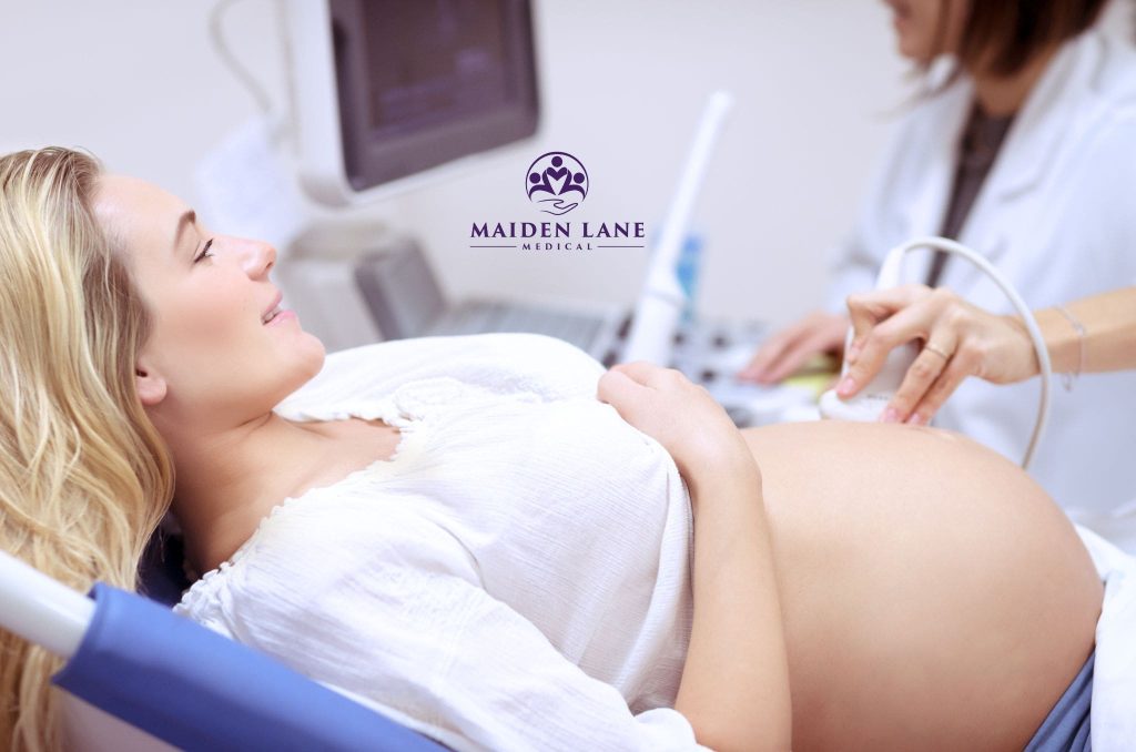 A relieved pregnant woman getting an ultrasound to rule out placenta previa.