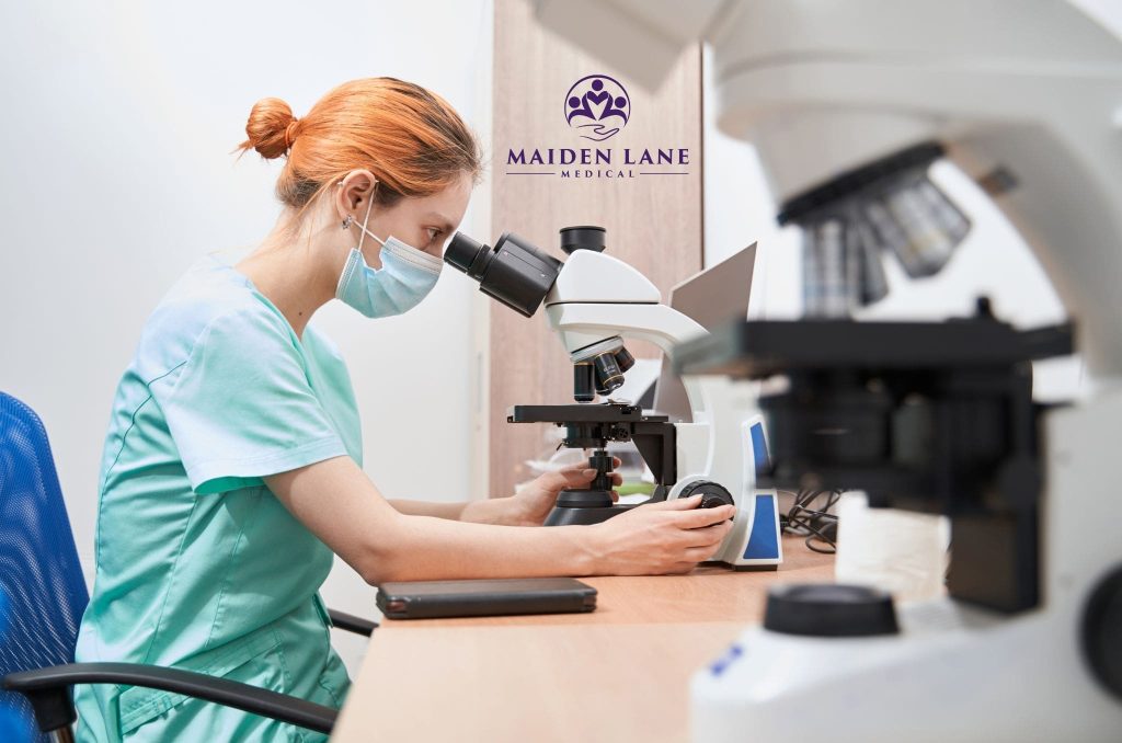 A doctor at Maiden Lane Medical checking for abnormal Pap smear results.