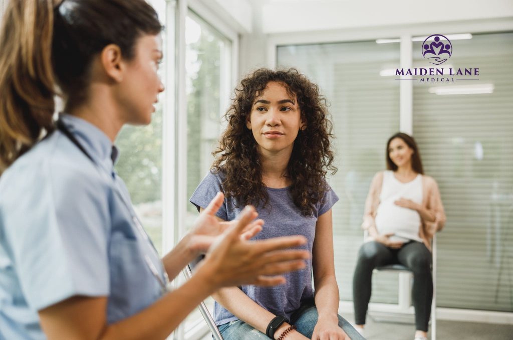 A woman talking to her gynecologist about fibroid removal surgery.