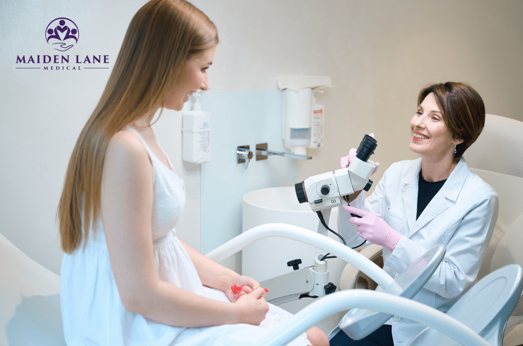 A gynecologist preparing a colposcope for her patient’s exam.
