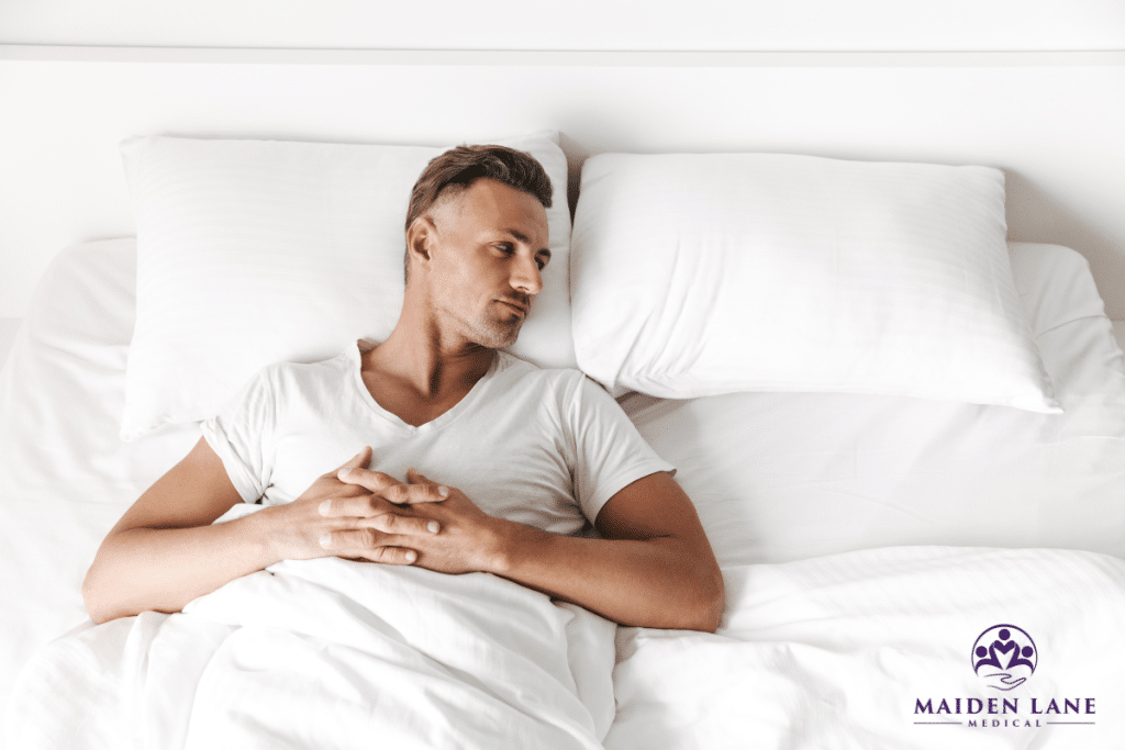 A man alone on a bed with confidence issues due to premature ejaculation in Manhattan, New York.