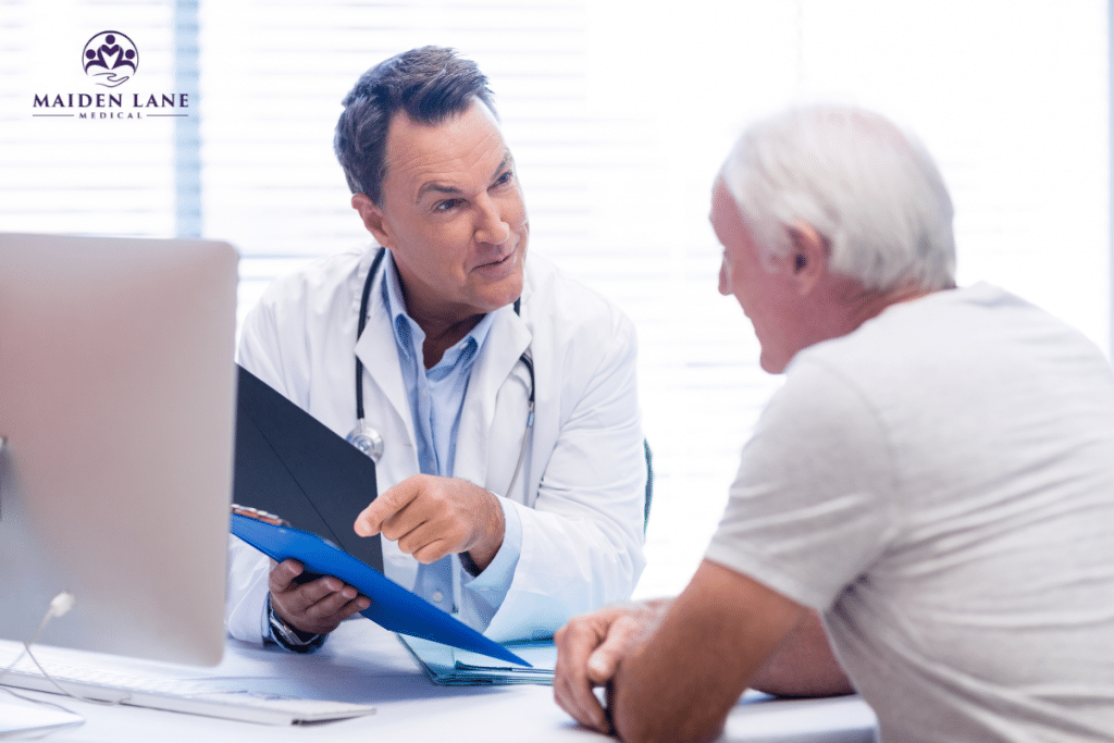A man at the doctor’s office for a prostate checkup talking to the doctor about his results in Manhattan, New York.