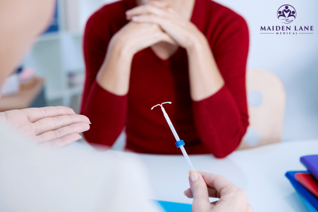 An IUD placement specialist is explaning the process to a woman looking for effective birth control methods in Manhattan, New York.