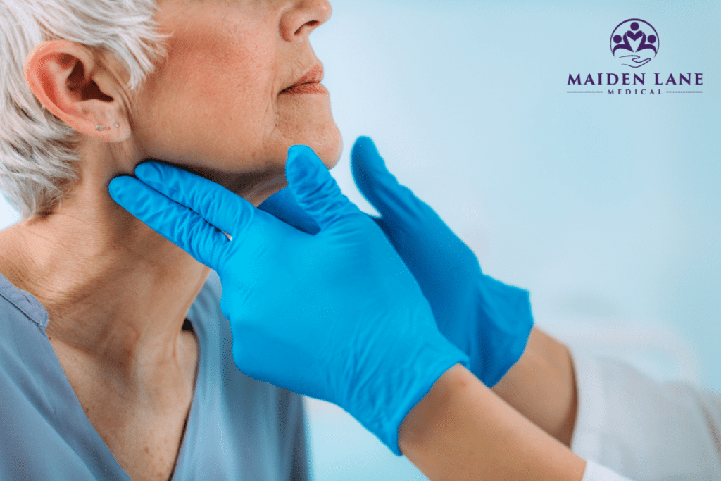 An endocrinologist examining an elderly patient’s thyroid in Manhattan, New York.