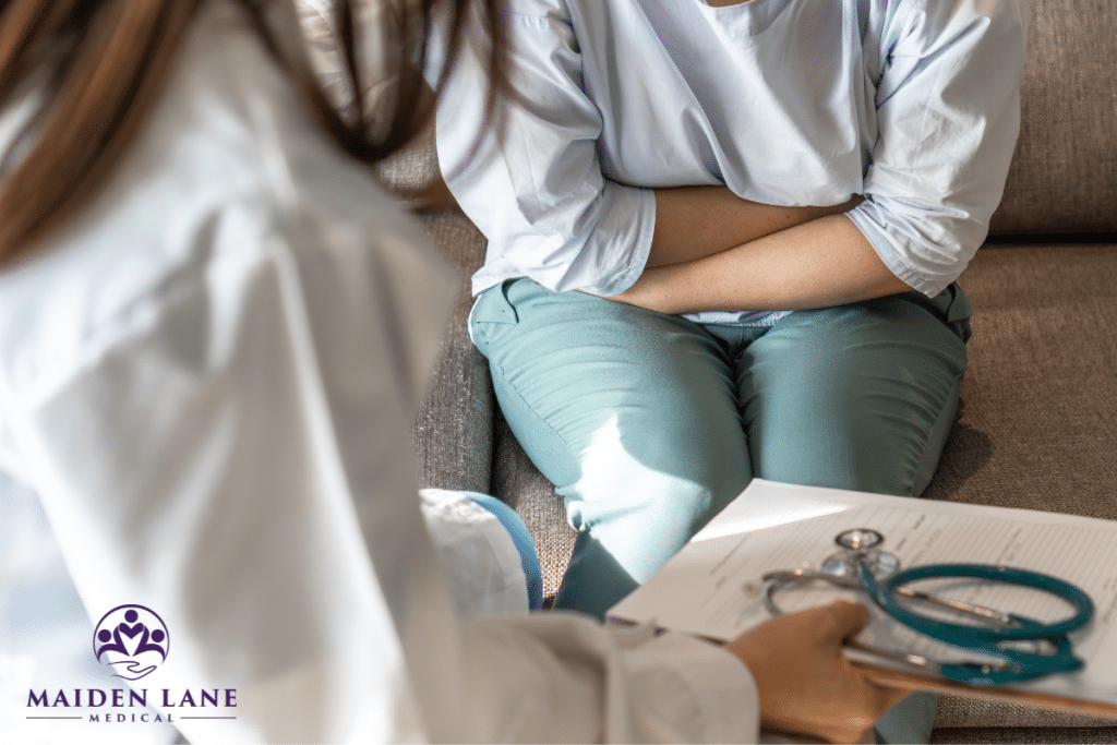 A woman experiencing pelvic pain is having a consultation with a specialist to find relief in Manhattan, New York.
