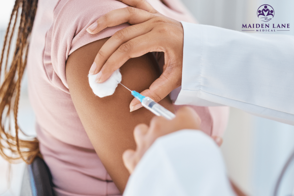 A doctor administering a vaccine to a woman in Manhattan, New York.